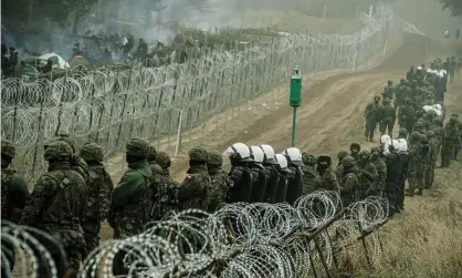  ?? Photograph: Reuters ?? Polish soldiers and police near Kuznica, on the border with Belarus.