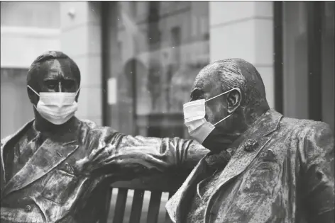  ?? ALBERTO PEZZALI VIA AP ?? FACE COVERINGS ON THE STATUES OF FORMER US PRESIDENT Franklyn D. Roosevelt (left) and former British Prime Minister Winston Churchill in Mayfair, London, on Sunday as the third national lockdown, due to the COVID-19 outbreak, continues.