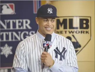  ?? The Associated Press ?? Giancarlo Stanton answers questions during a press conference introducin­g him as the newest member of the New York Yankees on Monday in Orlando, Fla.