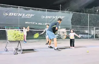  ?? ?? Night training in progress at Bukit Lima tennis courts.