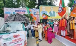  ?? — ASIAN AGE ?? Delhi BJP president Adesh Gupta flags off vehicles carrying 2 lakh saplings for planting in all districts in New Delhi on Tuesday.