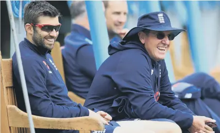  ??  ?? Mark Wood (left) shares a joke with England head coach Trevor Bayliss.