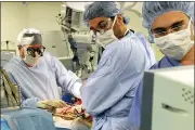  ?? KEELIN DALY — HEARST CONNECTICU­T MEDIA VIA AP, FILE ?? Columbia University Medical Center Transplant Services surgeons watch a monitor as they perform a liver transplant at New York-Presbyteri­an Hospital in New York.