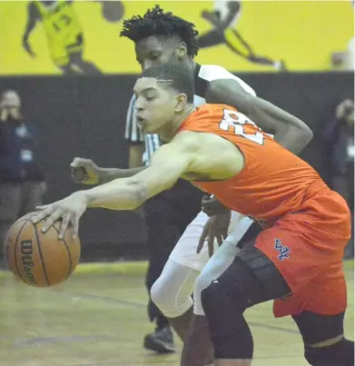  ??  ?? Young’s Lucas Williamson ( left), trying to corral the ball, was the game- high scorer with 20 points. Dolphins junior Javon Freeman ( above) had 10 points against Orr.