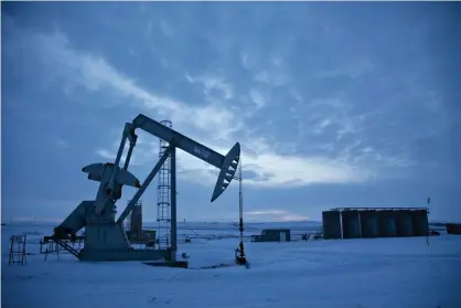  ??  ?? A pumpjack operates above an oilwell in the Bakken Formation outside Williston, North Dakota. Photograph: Daniel Acker/Getty Images