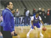  ?? The Associated Press ?? ACC FLAVOR: Duke coach Mike Krzyzewski, left, follows practice at the Blue Devils’ practice Thursday in Omaha, Neb. Duke faces Syracuse in a regional semifinal today.