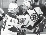  ?? KEITH SRAKOCIC/AP ?? Bruins defenseman Jarred Tinordi, right, is helped off the ice by teammate Steve Kampfer after taking a hit from the Penguins’ Brandon Tanev last week.