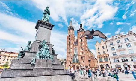  ?? DOMINIC ARIZONA BONUCCELLI/RICK STEVES’ EUROPE ?? Kraków’s Main Market Square, with St. Mary’s Church.