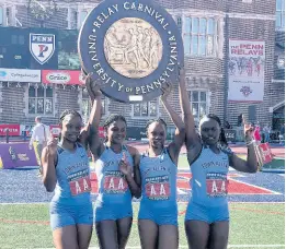  ?? FILE ?? Members of the Edwin Allen High School team celebrate with their plaque after a record run to capture the Championsh­ip of America 4x100 metres at the Penn Relays last year. From left: Tina Clayton, Brandy Hall, Tia Clayton and Serena Cole.