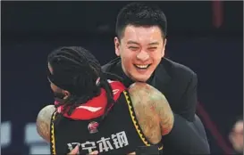  ?? ?? Liaoning head coach Yang Ming and center Eric Moreland embrace after winning the CBA championsh­ip title.