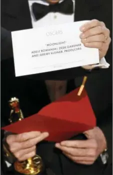  ?? CHRIS PIZZELLO — INVISION VIA AP ?? The envelope revealing “Moonlight” as the true winner of best picture is held up by “La La Land” producer Jordan Horowitz at the Oscars on Sunday at the Dolby Theatre in Los Angeles.