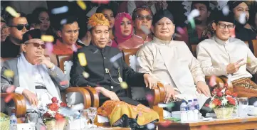  ??  ?? Widodo (second left) and his running mate Ma’ruf Amin (left) with Prabowo (second right) and his running mate Sandiaga Uno attend a peace declaratio­n for the upcoming general election campaign at the National Monument in Jakarta yesterday. – AFP photo