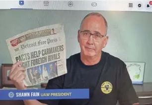  ?? ERIC D. LAWRENCE/DETROIT FREE PRESS ?? In this photo of a computer screen, UAW President Shawn Fain holds a Detroit Free Press from 2003 on Tuesday during a Facebook Live session as he discusses upcoming contract bargaining with Ford, General Motors and Stellantis.