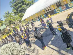  ??  ?? Students gather on the grounds of Green Island Primary School in Hanover before the start of face-to-face classes yesterday.