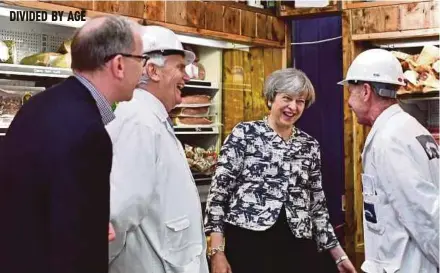  ?? REUTERS PIC ?? Prime Minister Theresa May and her husband, Philip, campaignin­g at Smithfield Market in London yesterday.