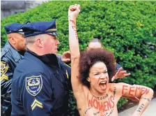  ?? COREY PERRINE/ASSOCIATED PRESS ?? Police arrest protester Nicolle Rochelle outside the courthouse in Norristown, Pa., Monday. Rochelle appeared in several episodes of ‘The Cosby Show’ as a child actor.