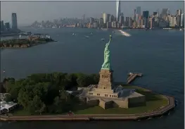  ?? BLOOMBERG ?? In New York, the state is paying $65,000 a day to operate the Statue of Liberty National Monument and Ellis Island during the federal government shutdown.