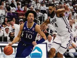  ?? Tony Gutierrez/Associated Press ?? Kansas forward Jalen Wilson (10) works to the basket as TCU’s Eddie Lampkin Jr. defends in the first half on Monday in Fort Worth, Texas.