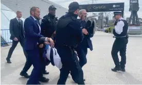  ?? ?? A protester from Fossil Free London is carried away by members of security at the ExCel centre, London. Photograph: Rebecca Speare-Cole/PA