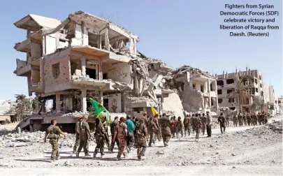  ??  ?? Fighters from Syrian Democratic Forces (SDF) celebrate victory and liberation of Raqqa from Daesh. (Reuters)