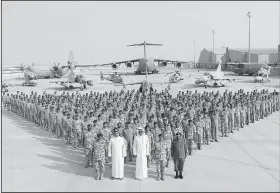  ?? AP/QNA ?? The Qatari Emir Sheikh Tamim bin Hamad Al Thani (center front) poses for a photo Monday with Emiri Air Force at al-Udeid Air Base in Doha, Qatar.