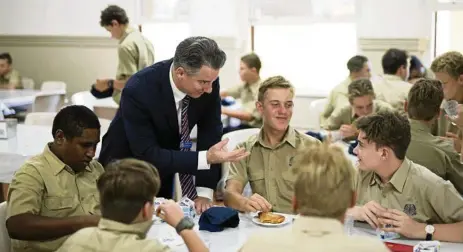  ?? PHOTO: BRODY GROGAN ?? STUDENT CARE: Christian Oneto, dean of boarding at Nudgee College, talks with students.