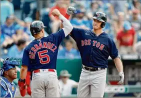  ?? Colin E. Braley / Associated Press ?? Kike Hernandez congratula­tes Bobby Dalbec, who hit a two-run homer in the ninth inning against Kansas City at Kauffman Stadium on Saturday.