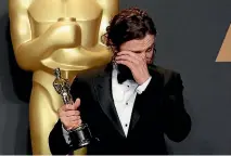  ??  ?? Casey Affleck weeps as he holds his Oscar for Best Actor for Manchester by the Sea.