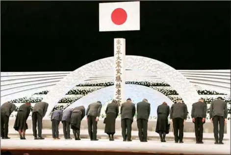  ?? (AP) ?? Bereaved family members bow in front of the altar for the victims of the March 11, 2011 earthquake and tsunami during the national memorial service in Tokyo on
March 11, 2017.