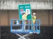  ?? Carol Kaliff / Hearst Connecticu­t Media ?? Workers put up signs in April under the Interstate 84 overpass near Exit 6 in Danbury. Constructi­on crews began work reconfigur­ing the exit and making upgrades to the roads April 2015.