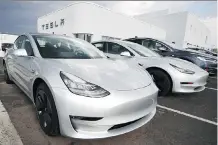  ?? DAVID ZALUBOWSKI/THE ASSOCIATED PRESS FILES ?? Model 3 sedans sit on display outside a Tesla showroom in Littleton, Colo., last month.