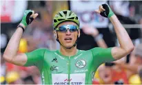  ?? CHRISTOPHE ENA/THE ASSOCIATED PRESS ?? Germany’s Marcel Kittel, wearing the best sprinter’s green jersey, celebrates as he crosses the finish line Tuesday to win the 10th stage of the Tour de France cycling race in Bergerac, France.