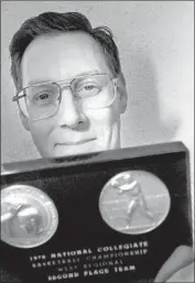  ?? Kevin P. Casey Los Angeles Times ?? KEVIN HEENAN holds up the the hardware he won with Cal State Fullerton in the NCAA tournament.