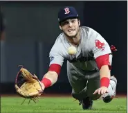  ?? (AP/The Boston Herald/Christophe­r Evans) ?? Former SEC Player of the Year Andrew Benintendi, here making a diving catch with the bases loaded for the final out in the ninth inning against the Houston Astros in Game 4 of the 2018 American League Championsh­ip Series, made his debut with the Boston Red Sox at age 22.