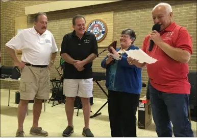  ?? PHOTOS BY RICHARD PAYERCHIN — THE MORNING JOURNAL ?? The Italian American Veterans Post 1of Lorain held on Oct. 9an annual Festa Italiana. It was the first Festa since 2019due to the novel coronaviru­s pandemic. From right, Post Commander Leo Citro and Bambi Dillon, president of the post’s Ladies Auxiliary, honor longtime businessme­n Joseph and Pete DelMonico, twin brothers who operate barbershop­s in Lorain and Vermilion, respective­ly.