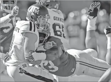  ??  ?? Brynn Anderson / The Associated Press Alabama defensive lineman Jonathan Allen (right) sacks Texas A&M quarterbac­k Trevor Knight during the first half.