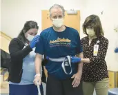  ?? ?? Physical therapist Paula Savino, right, and occupation­al therapist Jaclyn Lavigne help John Bysiewicz.