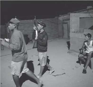  ?? RODRIGO ABD / THE ASSOCIATED PRESS ?? Members of the Marval family patrol at night while relatives fish in Punta de Araya, Venezuela. The Marvals allege that 19-year-old killer “El Beta” murdered three of their family members at sea and threatened more attacks.