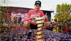  ?? — AFP ?? Happy man: Chris Froome posing with the trophy after winning the Giro d’Italia in Rome on Sunday.