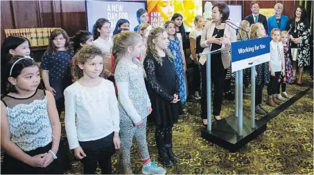  ??  ?? B.C. Minister of State for Child Care Katrina Chen, centre, turns to Victoria West Elementary students during an announceme­nt at the legislatur­e library about new child-care spaces for six elementary schools in the capital region, the result of a partnershi­p between the provincial government and and the Greater Victoria School District.