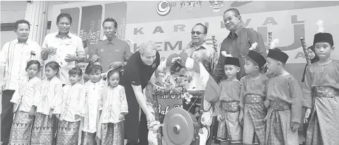  ??  ?? Awang Tengah hitting the gong to mark the launch of Kemas4U Carnival.