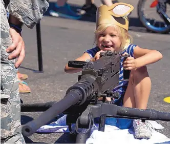  ?? GREG SORBER/JOURNAL ?? Six-year-old Saylor Thomas of Rio Rancho checks out a .50-caliber machine gun on display at the New Mexico Air National Guard booth during Military & Veterans Appreciati­on Day at the New Mexico State Fair on Tuesday. Today and Sunday are your last...