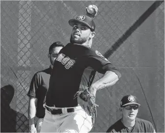  ?? Yi-Chin Lee / Staff photograph­er ?? After joining the team in midseason last year, reliever Roberto Osuna is eagerly anticipati­ng his first full season with the Astros. He worked on his pitches in the bullpen Friday at Fitteam Ballpark.