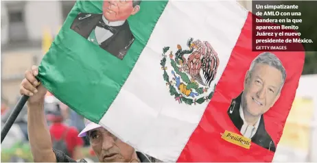  ?? GETTY IMAGES ?? Un simpatizan­te de AMLO con una bandera en la que aparecen Benito Juárez y el nuevo presidente de México.