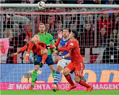  ?? AFP ?? Bayern’s Robert Lewandowsk­i takes an overhead kick during the match against Schalke. —