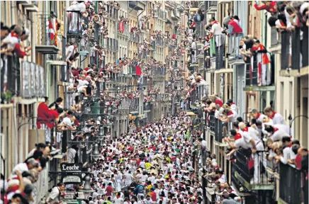  ??  ?? Thousands of people filled the streets of Pamplona, in Spain, for the city’s annual Running of the Bulls festival in which crowds attempt to outpace a herd of cattle. Runners at the event, popular with tourists after Ernest Hemingway wrote of it,...