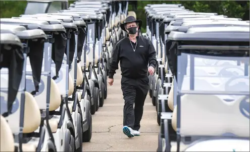  ?? Photo by Jonathan Newton / The Washington Post ?? Golfer Joe O’Connor walks to his cart at the start of a round of golf during the COVID-19 pandemic. Golf has given athletes an outlet to do something physically.