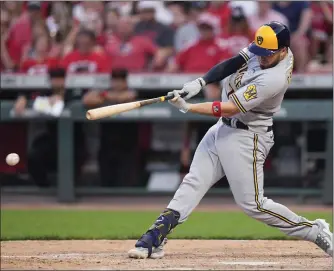  ?? AP PHOTO/JEFF DEAN ?? Milwaukee Brewers’ Victor Caratini hits an RBI single against the Cincinnati Reds during the 11th inning of a baseball game in Cincinnati, Friday, June 2, 2023.