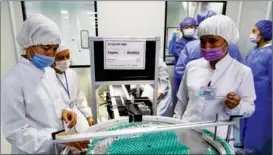  ?? ZAFAR KHALILOV / XINHUA ?? Production of a Chinese-developed COVID-19 vaccine takes place at a facility run by Jurabek Laboratori­es in Uzbekistan on Sept 5. The vaccine went into production at the plant as part of cooperatio­n between the two countries.