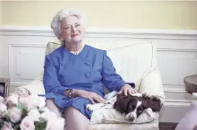  ??  ?? Then-first lady Barbara Bush poses with her dog Millie in Washington in 1990. Bush died Tuesday at her home in Houston. She was 92.